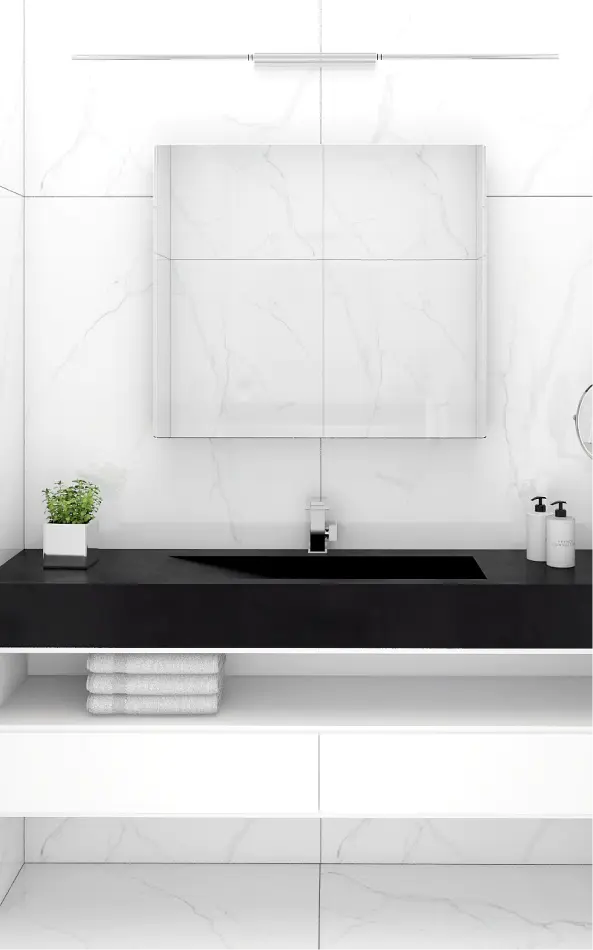 a bathroom with a black sink and white cabinets